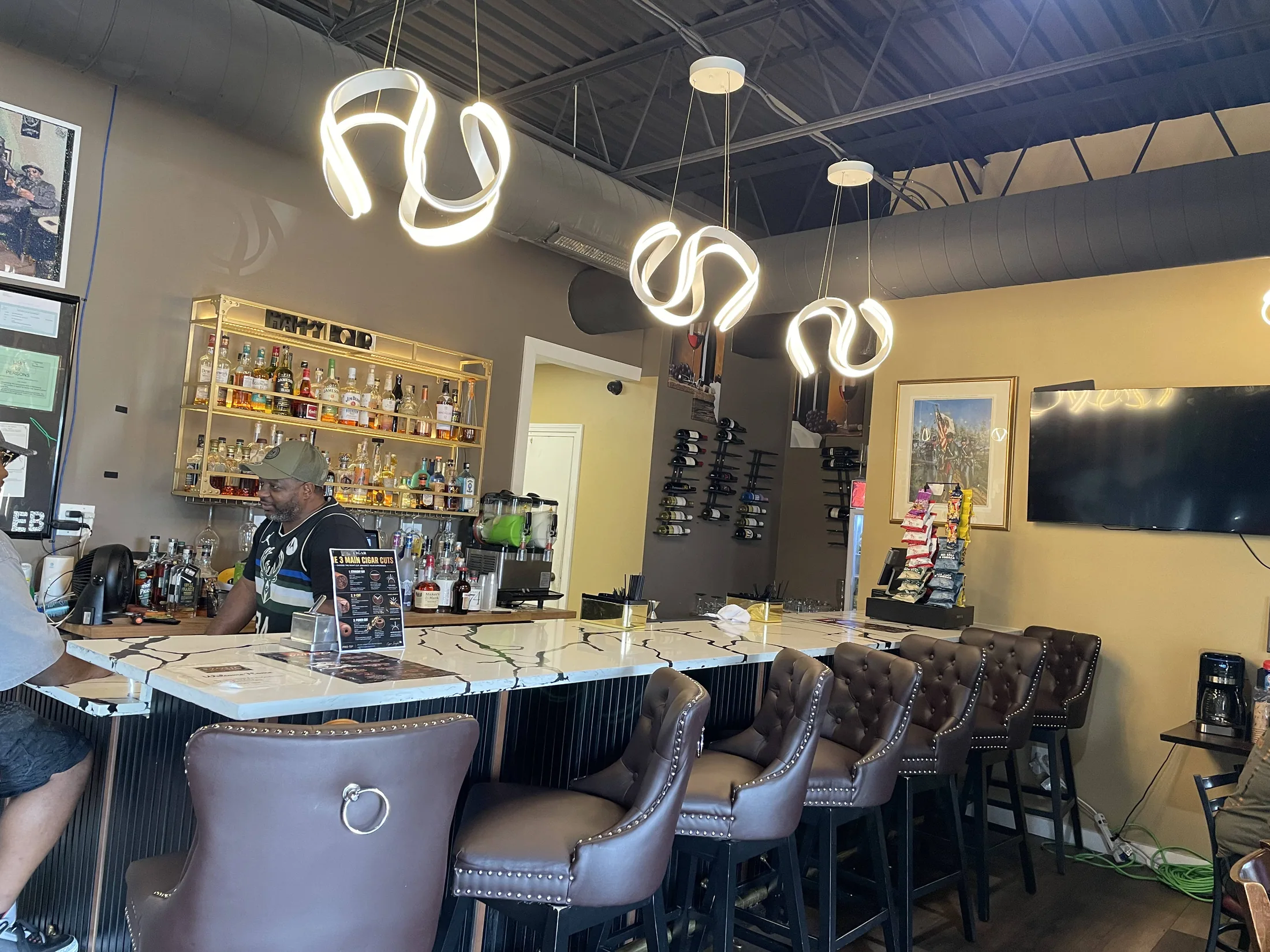 The marble-topped bar, proprietary whiskey, and leather seating inside Exotic Blends Cigar Lounge